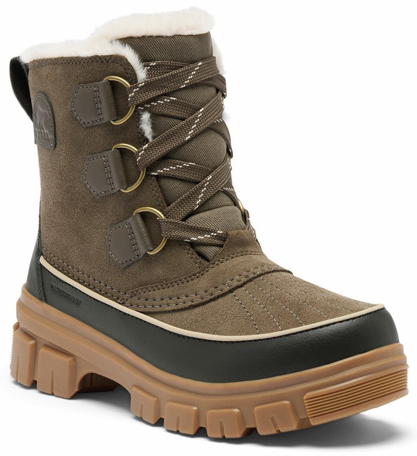 A brown suede winter boot with a thick light brown lugged rubber sole, a dark brown waterproof rubber lower trim, lace-up front with metal eyelets, and white faux-fur trim along the top opening.