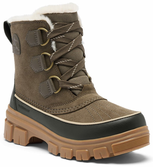 A brown suede winter boot with a thick light brown lugged rubber sole, a dark brown waterproof rubber lower trim, lace-up front with metal eyelets, and white faux-fur trim along the top opening.