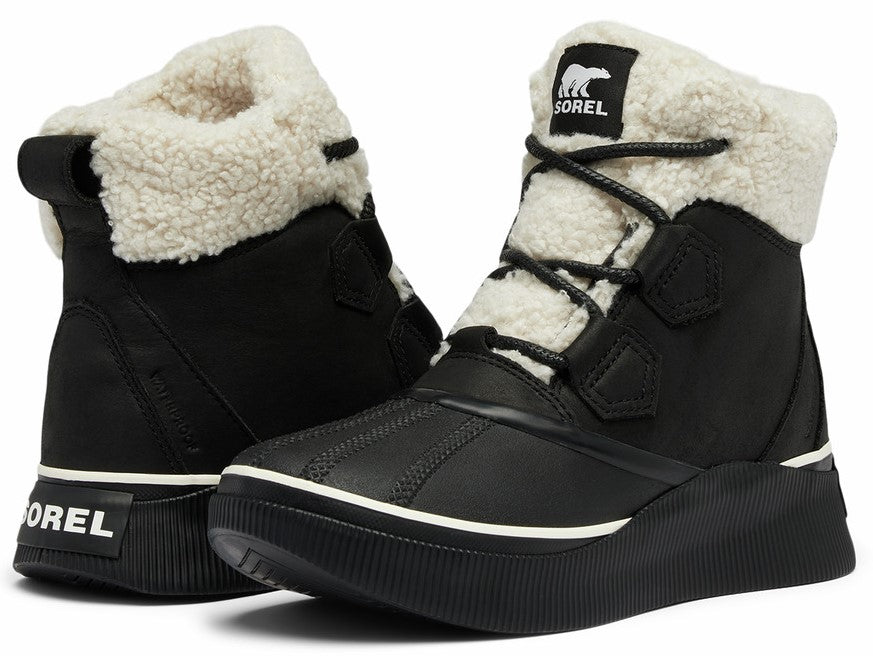 Pair of black lace-up boots with white shearling lining and "SOREL" text on the back.