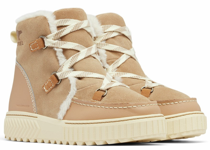 Tan suede winter boots with cream-colored laces and shearling lining.