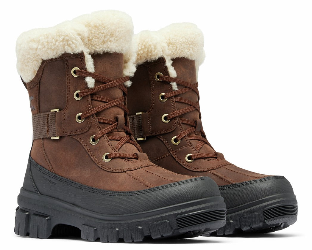 A pair of brown lace-up boots with white fur trim and black lug soles.