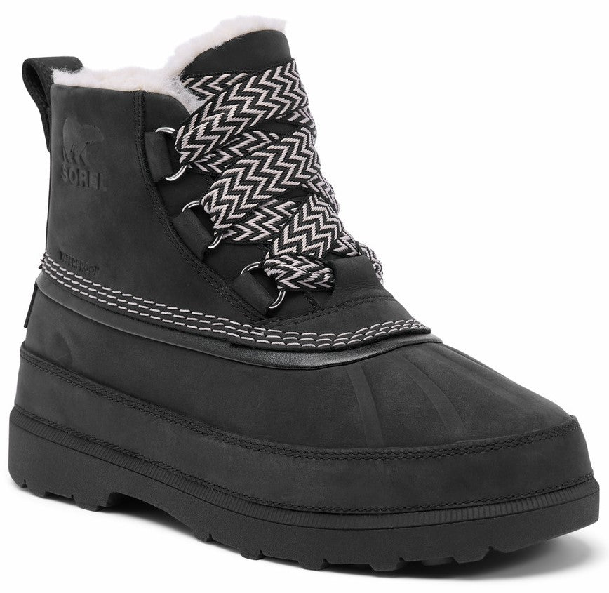 A black waterproof lace-up winter boot with a faux fur-lined ankle, chevron-patterned laces, and a thick, ridged rubber sole. The boot features a side pull tab, metal eyelets, and the embossed Sorel logo on the outer ankle.