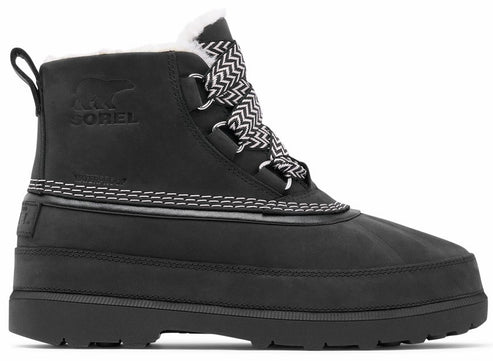 A black waterproof boot with a white fuzzy collar, featuring zigzag pattern laces, visible contrast stitching along the middle, a thick lug sole, and a debossed bear logo on the side.