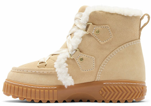 A tan suede lace-up boot with white faux-fur trim along the collar and tongue, gold-tone metal eyelets, a white braided lace, and a thick, textured brown rubber sole.