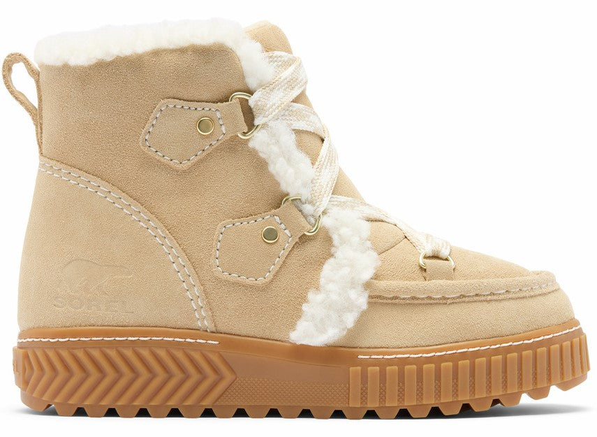 A tan suede lace-up boot with white faux-fur trim along the laces and collar, featuring a thick brown textured rubber platform sole and a small bear logo embossed on the side.