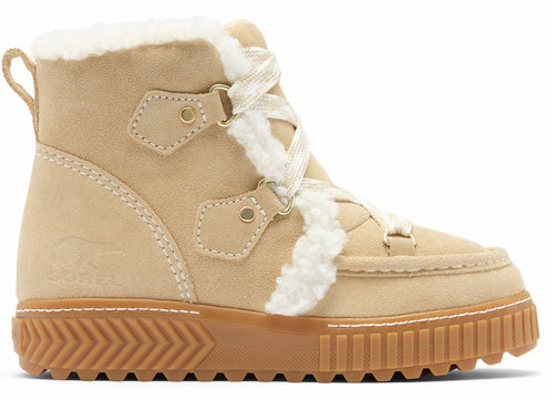 A tan suede lace-up boot with white faux-fur trim along the laces and collar, featuring a thick brown textured rubber platform sole and a small bear logo embossed on the side.