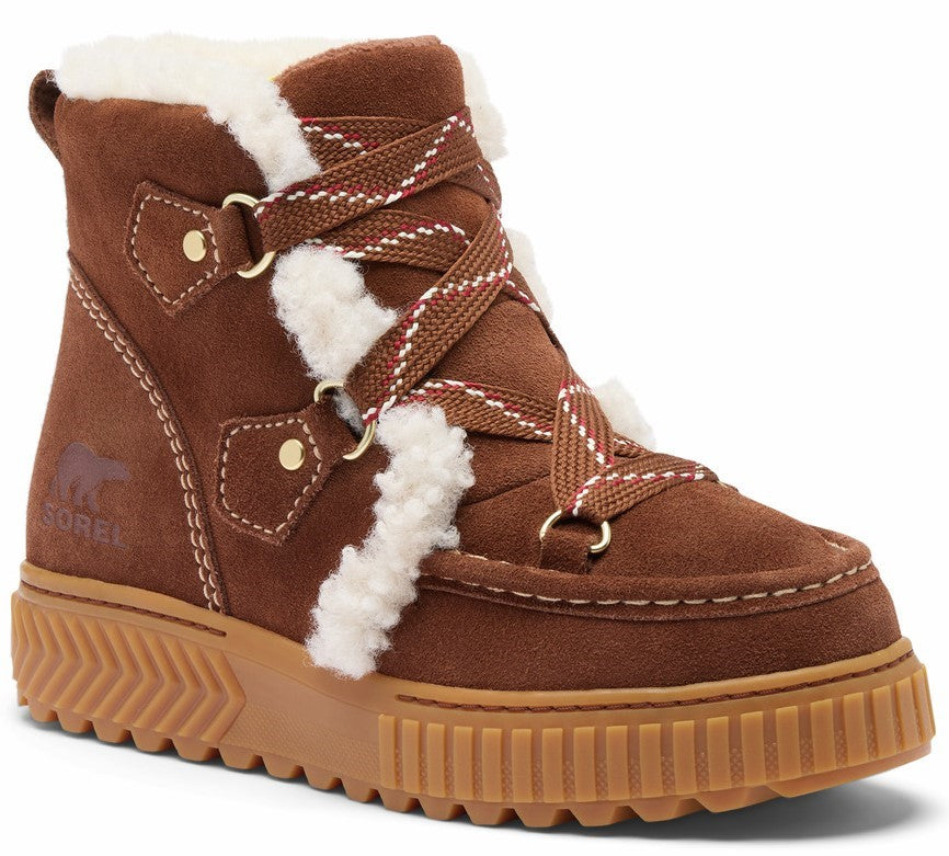 A brown suede winter ankle boot with a thick tan rubber platform sole, shearling lining around the ankle and tongue, crisscross lacing with gold-tone hardware, and a Sorel logo embossed on the outer side.