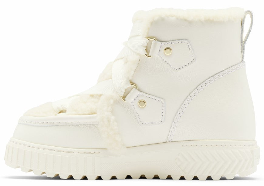 A profile view of a white lace-up winter boot with a thick, ridged sole, plush faux-fur lining around the ankle and tongue, gold-tone metal D-ring eyelets, and a pull loop at the heel.