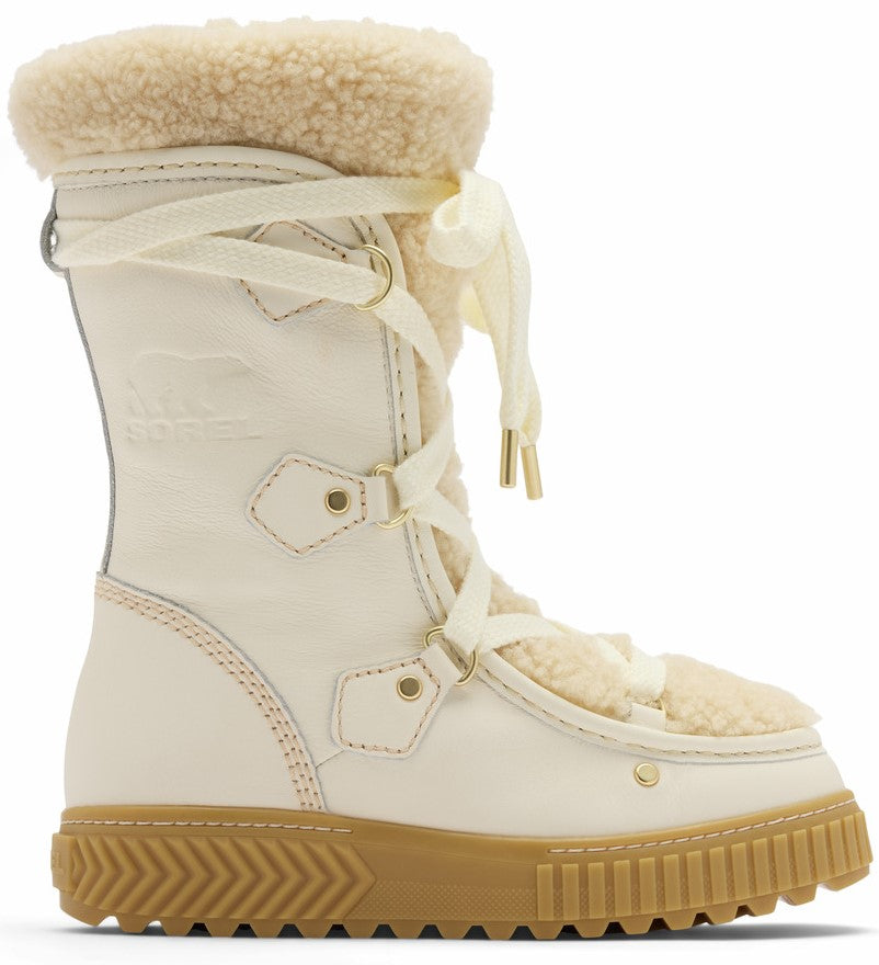A cream-colored SOREL mid-calf winter boot with a fleece-lined cuff, matching lace-up closure with gold-toned eyelets, and a thick, textured tan rubber platform sole.