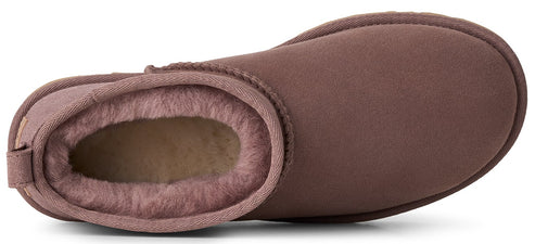A top-down view of a dusty-rose colored sheepskin ankle boot with a beige shearling lining.