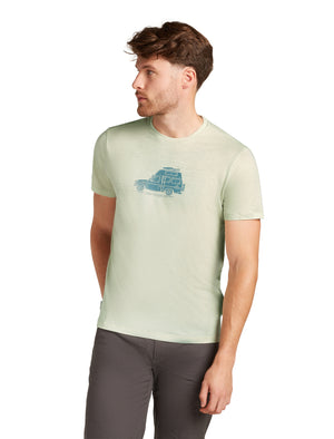 Man wearing light green t-shirt with car design, gray pants.