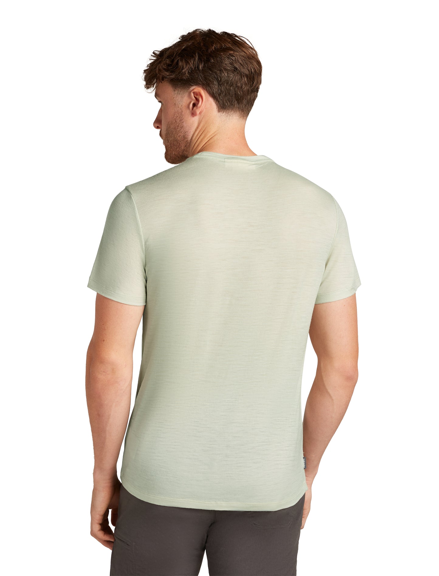Man wearing a light green short-sleeve t-shirt, back view.