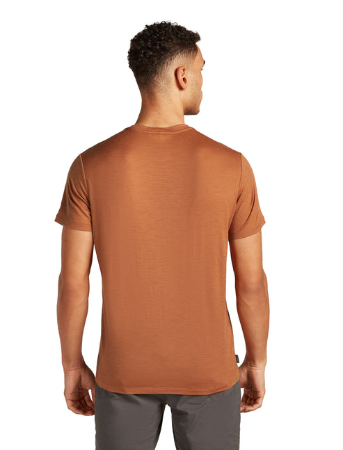 A light brown short sleeve t-shirt on a person from the back.