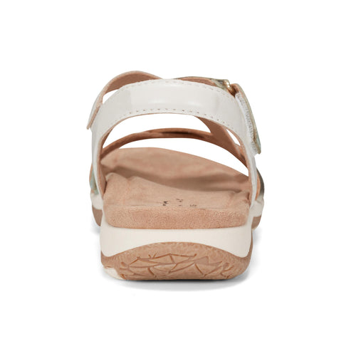 Back view of a sandal with white straps and tan sole.
