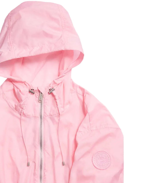 A light pink, hooded zip-up windbreaker with silver hardware and a circular embossed logo patch on the left sleeve.
