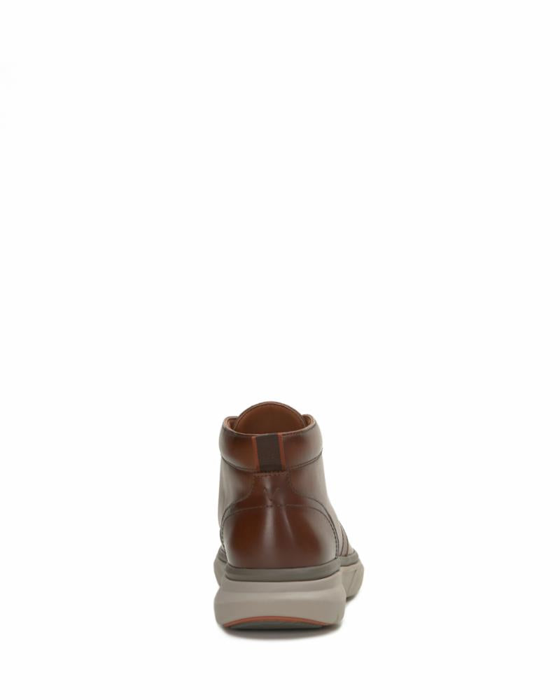 Rear view of a brown leather ankle boot with a thick, light gray sole.