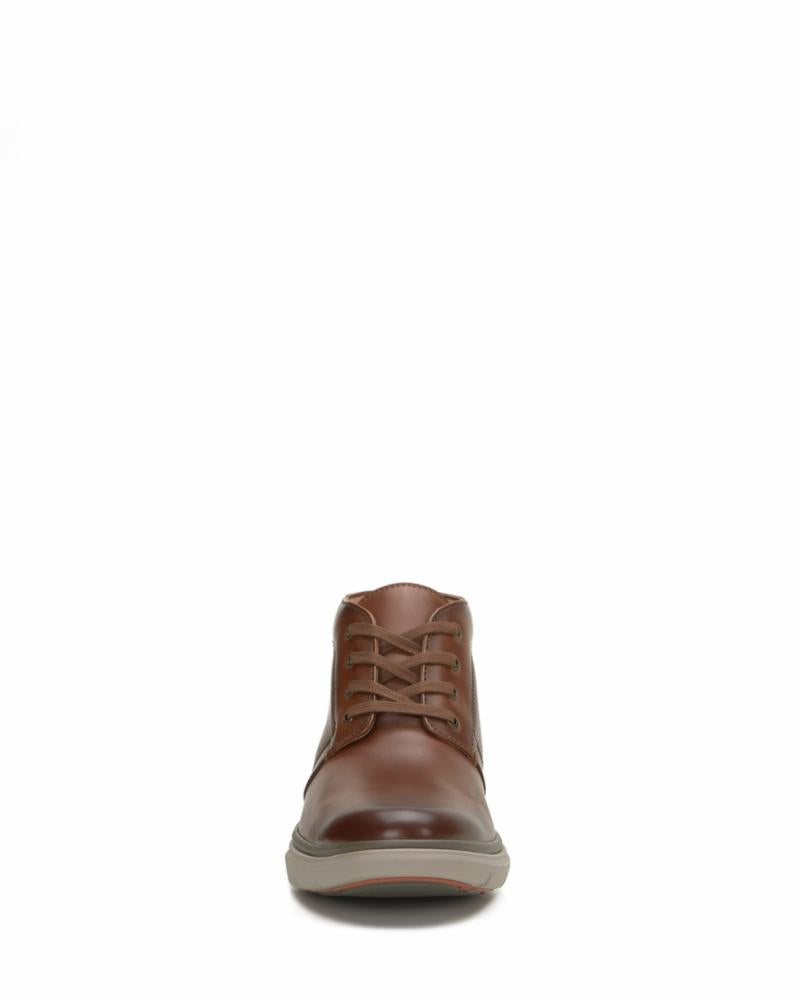 Front-facing view of a brown leather chukka boot with laces.