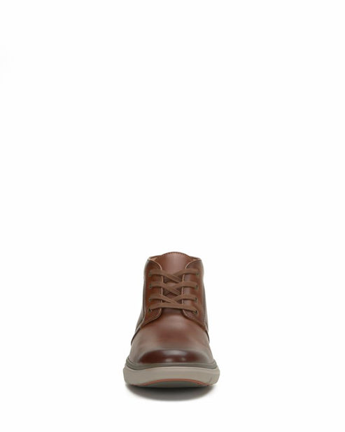 Front-facing view of a brown leather chukka boot with laces.
