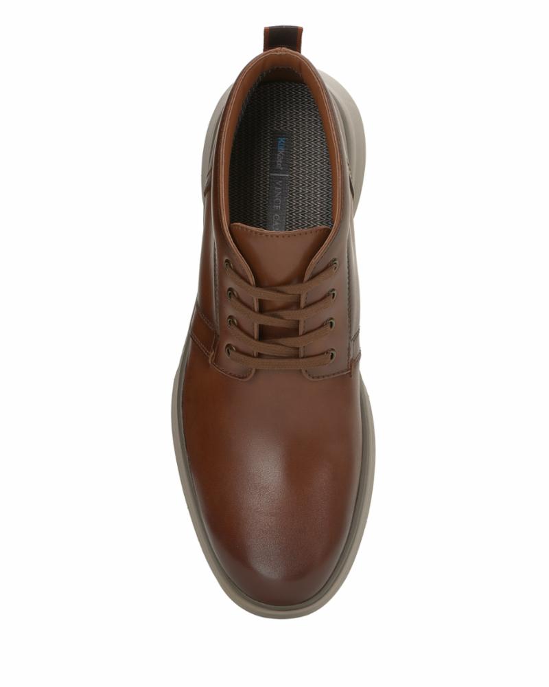 Top-down view of a tan leather lace-up dress shoe with a visible inner lining.