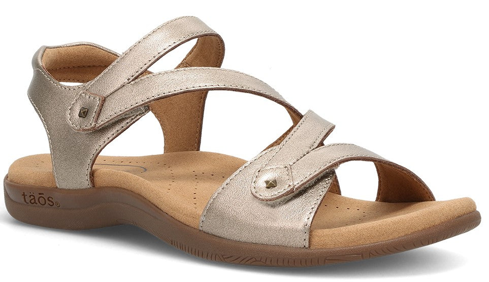 A tan sandal with multiple velcro straps.