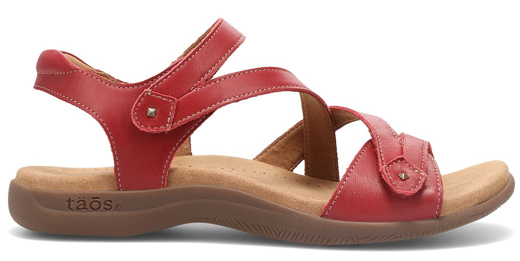 Red sandal with adjustable hook-and-loop straps and a brown footbed.