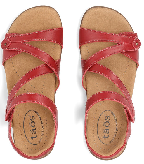Pair of red leather sandals with multiple criss-crossing straps and adjustable buckles, seen from above.