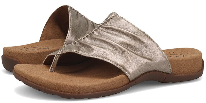 A pair of metallic thong sandals.