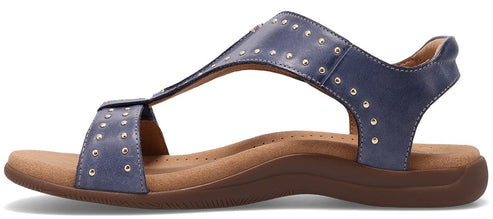 A blue sandal with metallic studs.