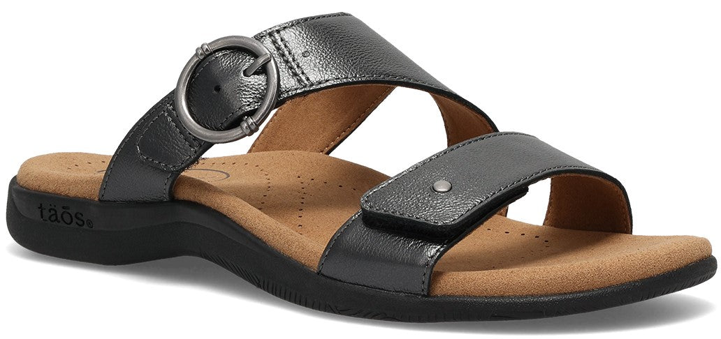 A metallic-gray sandal with two straps, one wide with a silver buckle and one adjustable with a stud.