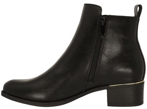 A black ankle boot with a side zipper, a low block heel, and a metallic accent between the heel and the sole.