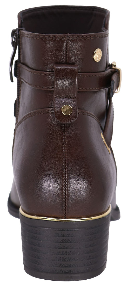 A back view of a brown faux leather ankle boot with a low block heel, featuring a metallic gold band above the heel, a buckled strap detail, and gold stud accents.
