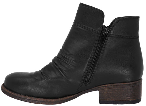 A black ankle boot with a side zipper closure, featuring a soft, scrunched leather upper and a low, dark brown block heel.