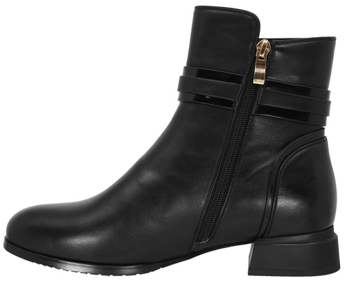 A black ankle boot with a rounded toe, a low block heel, a side zipper with a gold-tone pull, and two decorative, shiny black strap accents across the ankle.