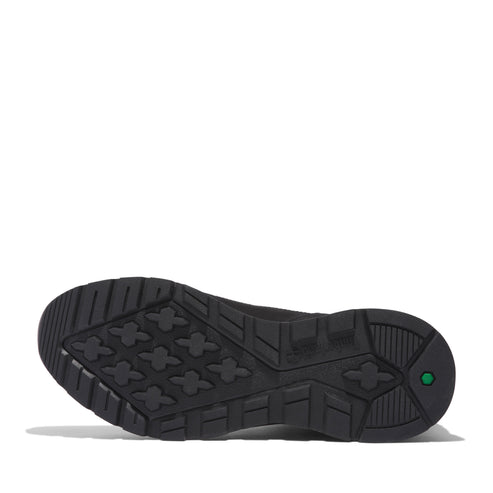 Black shoe sole with textured geometric pattern and a green logo.