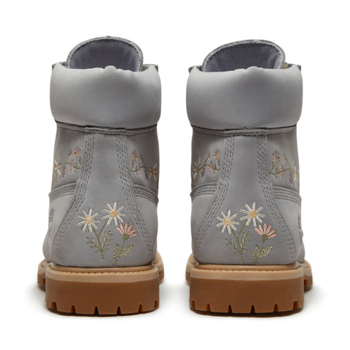 Two gray leather boots with floral embroidery, view from the heel.
