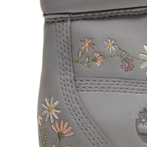Close-up of gray boot with embroidered daisy design.