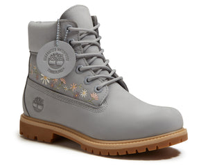 Gray leather boot with floral embroidery near the ankle and a thick, ridged sole.