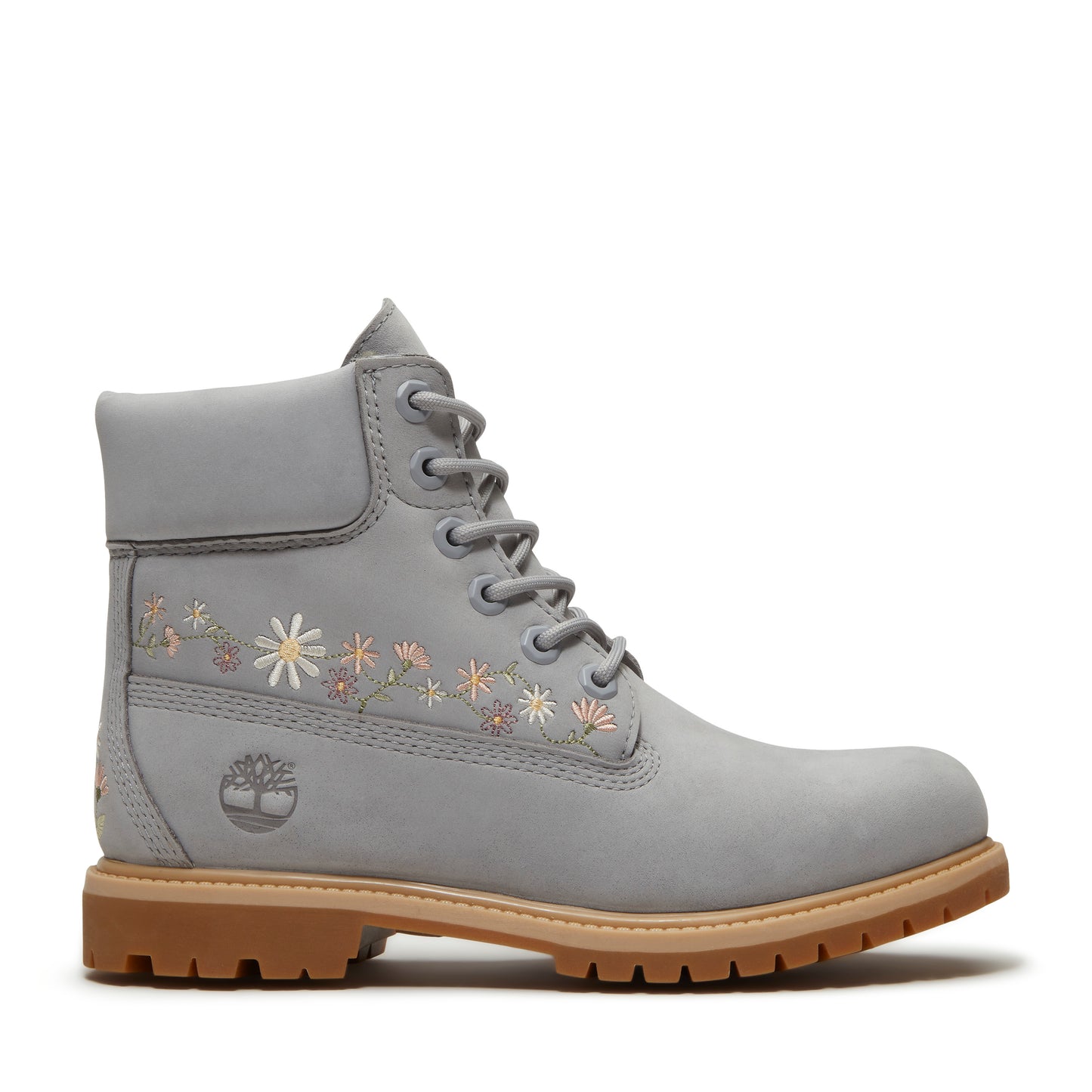 Gray ankle boot with a tan sole and flower embroidery.