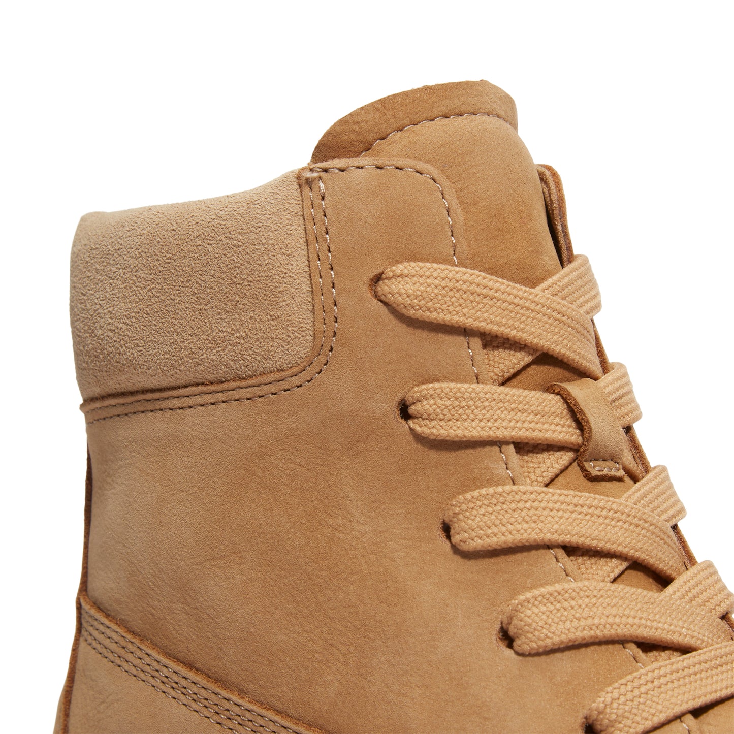 Close-up of the upper portion of a tan ankle boot with laces.