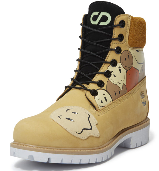 Tan-colored work boot featuring an ankle height, black laces, tan padded ankle, white lug sole, and smiling face details throughout.