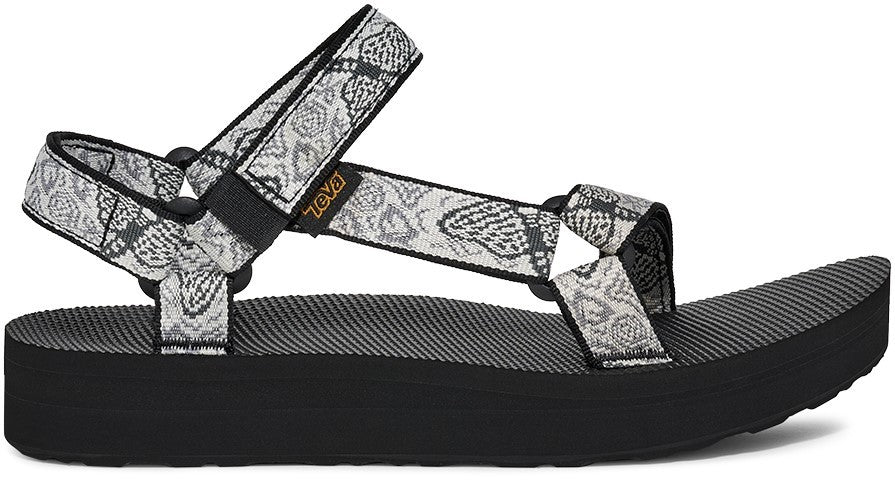 A platform sandal with patterned straps and a black sole.