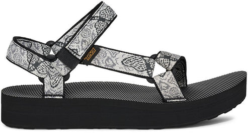 A platform sandal with patterned straps and a black sole.