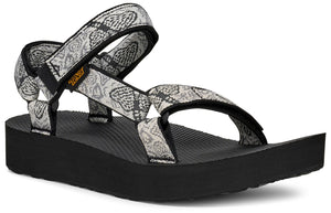 Platform sandal with black sole and printed fabric straps with a snake-like pattern.