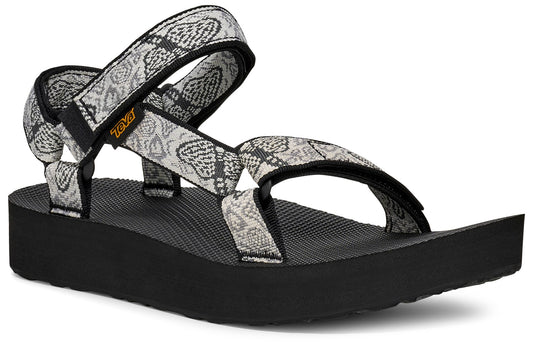 Platform sandal with black sole and printed fabric straps with a snake-like pattern.