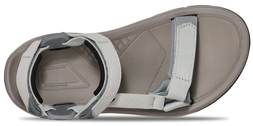 The bottom view of a sandal with light gray straps.