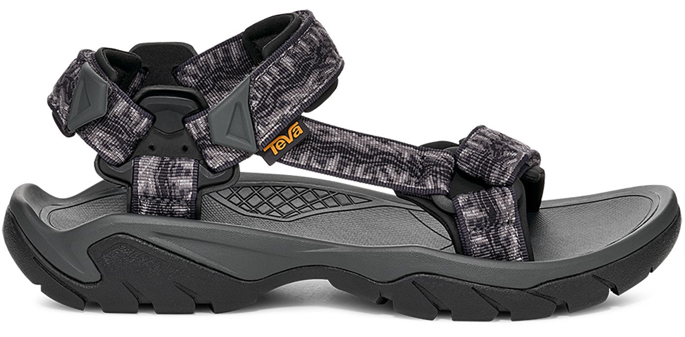 A sandal with a gray and black patterned strap.