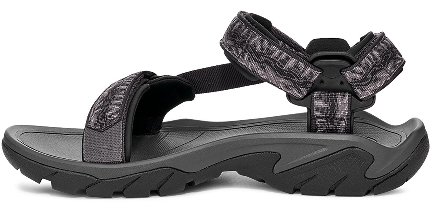 A sandal with gray and black straps and a contoured sole.