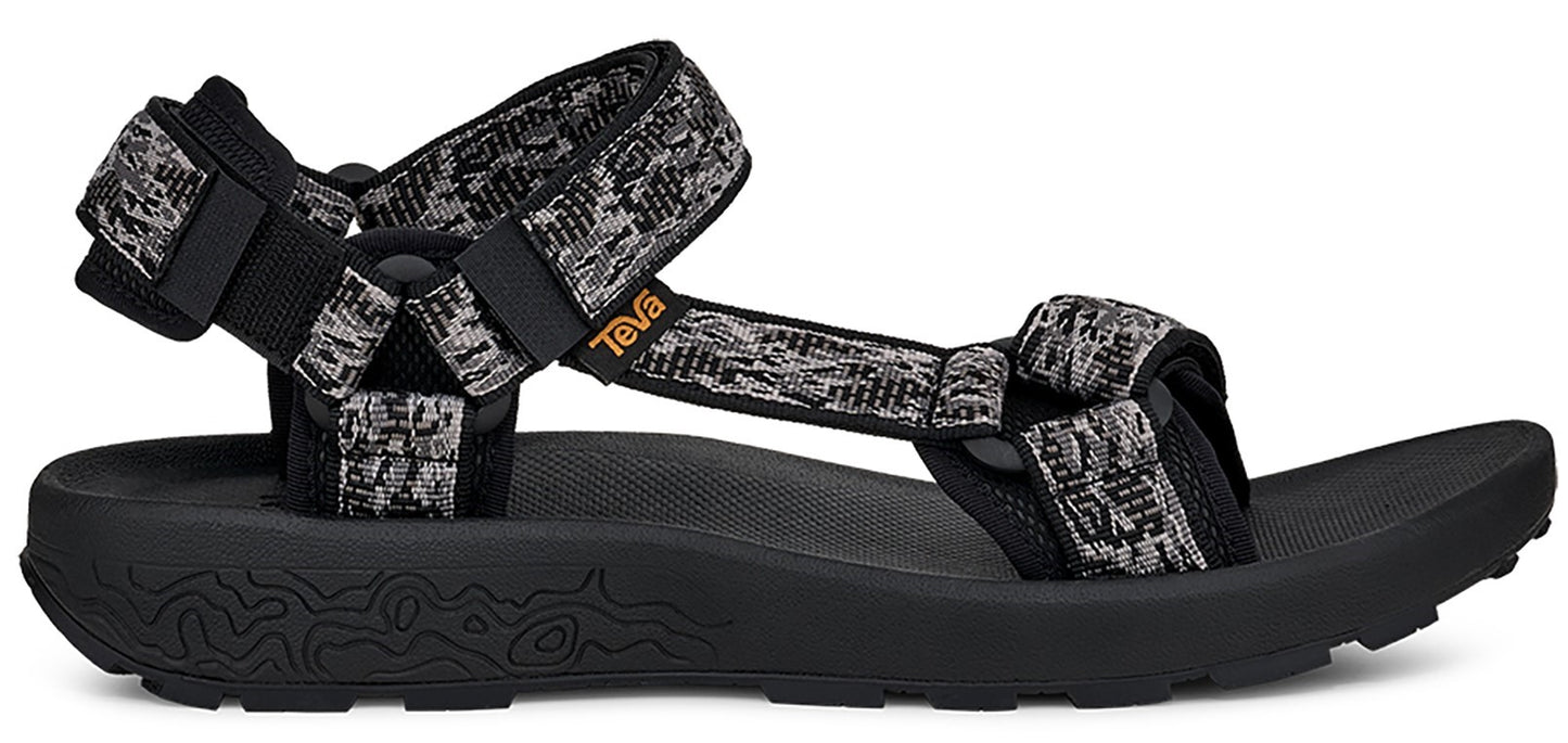 A black sandal with patterned straps.