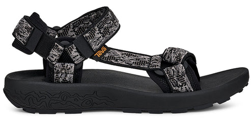 A black sandal with patterned straps.