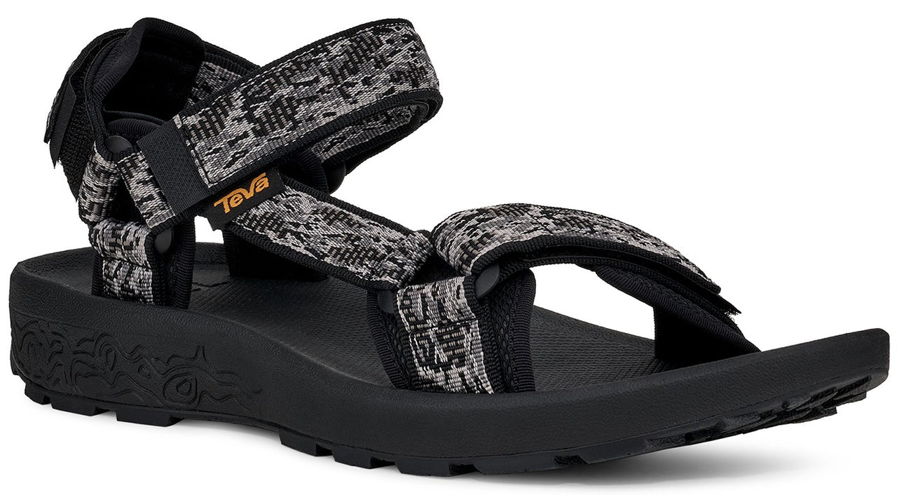 Black sandal with patterned gray, black, and white straps and a black sole.
